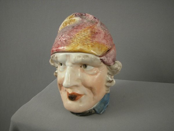 Majolica humidor of man with multi-color cap, mino: Majolica humidor of man with multi-color cap, minor rim nicks to lid, 5 3/4"