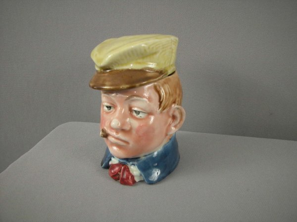 Majolica humidor of train conductor with yellow ha: Majolica humidor of train conductor with yellow hat, 4 3/4"