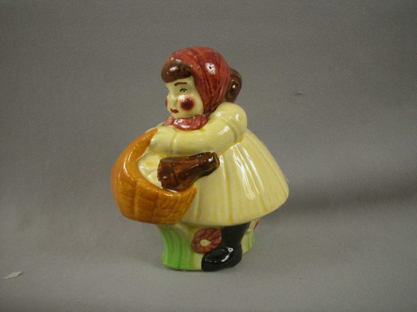 SARREGUEMINES figural ceramic bank in the form of : SARREGUEMINES figural ceramic bank in the form of a lady dressed as Little Red Riding Hood with basket, ref: Bottero p. 40, 5"