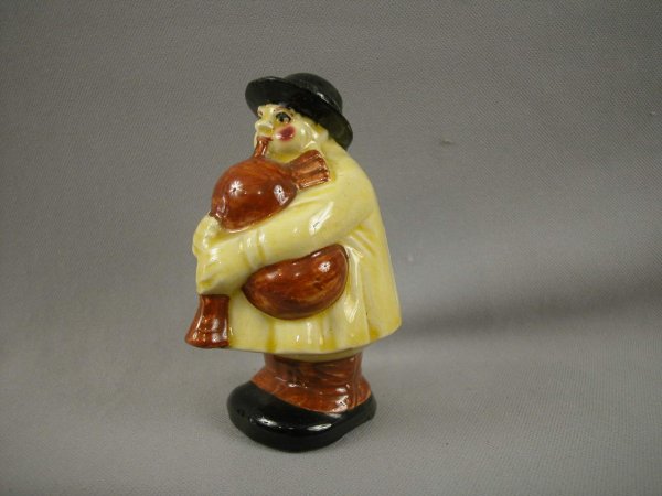 SARREGUEMINES figural ceramic bank in the form of : SARREGUEMINES figural ceramic bank in the form of a man playing a bag pipe, 5", ref: Bottero p. 32, repair to hat rim