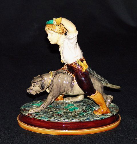 MINTON majolica figure of man with horn and sword: MINTON majolica figure of man with horn and sword leading hunting dog, rare form, 10", professional repair to dog's tail and sword, shape no. 403, modeled by E. Jeannest, a similar example is mounted