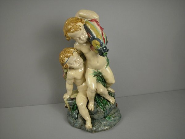 MINTON monumental Amorini Fountain modelled as a c: MINTON monumental Amorini Fountain modelled as a cherub seated on a rocky base strewn with seaweed and a fishing net , supporting another cherub balancing a dolphin on his shoulder, with water spout i
