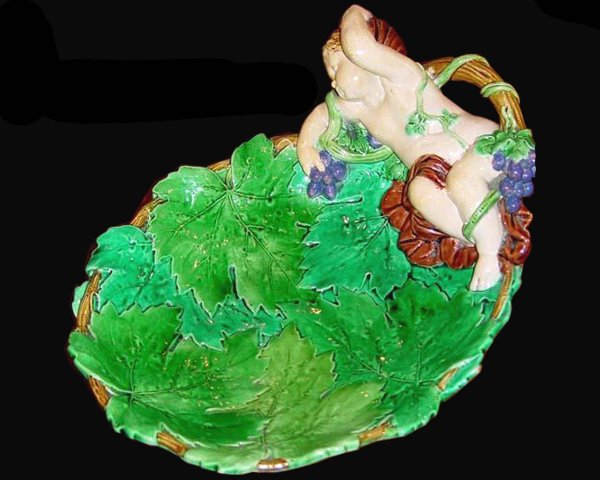 MINTON majolica amusing grape server modelledas a: MINTON majolica amusing grape server modelledas a leafage dish with a drunken cherub, grapes and vines, 11"l