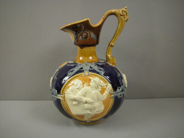 MINTON majolica Renaissance wine ewer with cobalt : MINTON majolica Renaissance wine ewer with cobalt ground and panels of men on each side and ram's head handle, 14", shape 1143