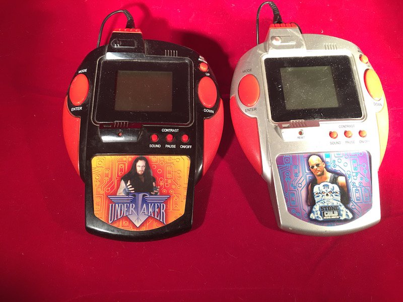 Lot of 2 WWE wrestling handheld games: Untested missing battery cover.