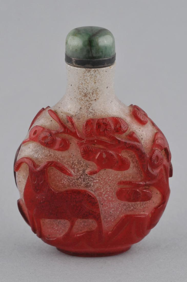 Snuff bottle. China. 19th century. Cameo glass red cut: Snuff bottle. China. 19th century. Cameo glass red cut to snowflake. Decoration of deer and a pine tree. 3". For additional and high-resolution images, please copy and paste the following link: https: