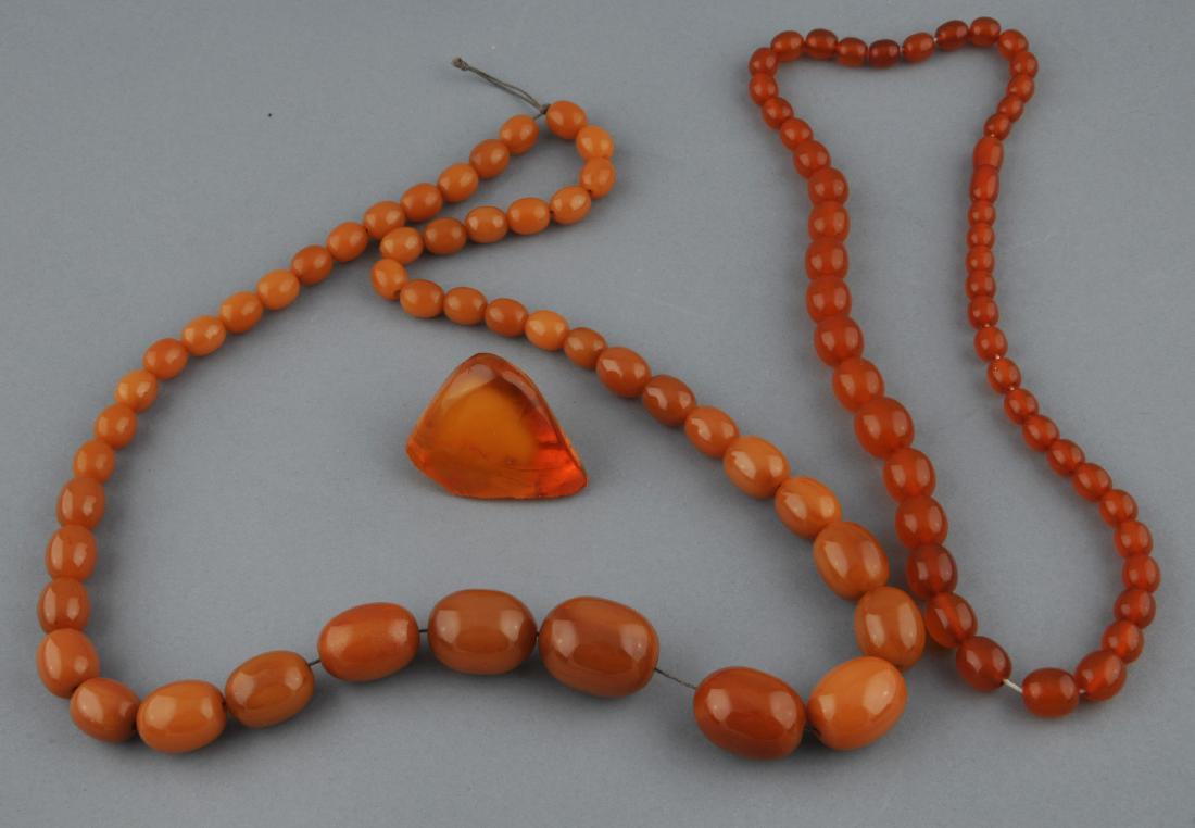 Lot of amber. To include: Two necklaces and a polished (1 of 6)