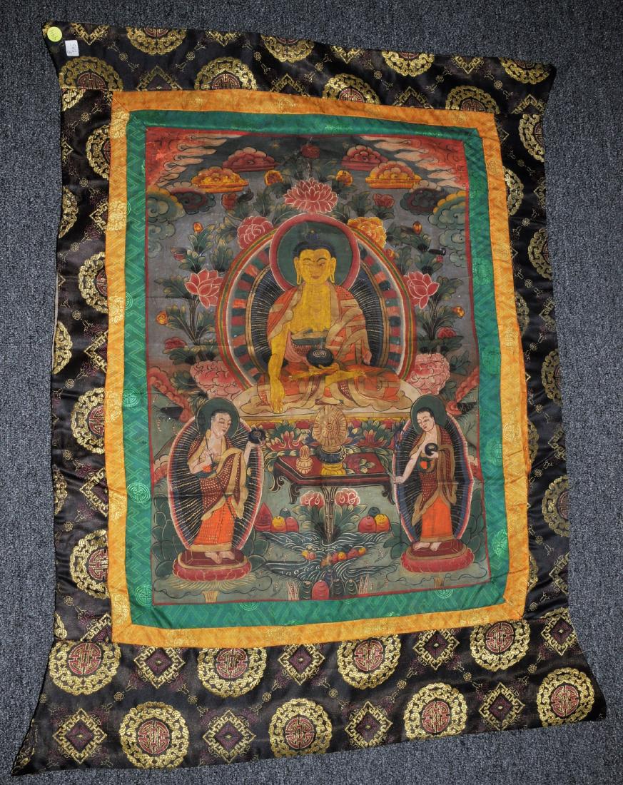 Buddhist Icon Thangka. Tibet. 20th century. Distemper.: Buddhist Icon Thangka. Tibet. 20th century. Distemper on cloth. Image of Shakyamuni Buddha with two attendants. 25-1/2" x 19". Brocade mounts. For additional and high-resolution images, please copy an