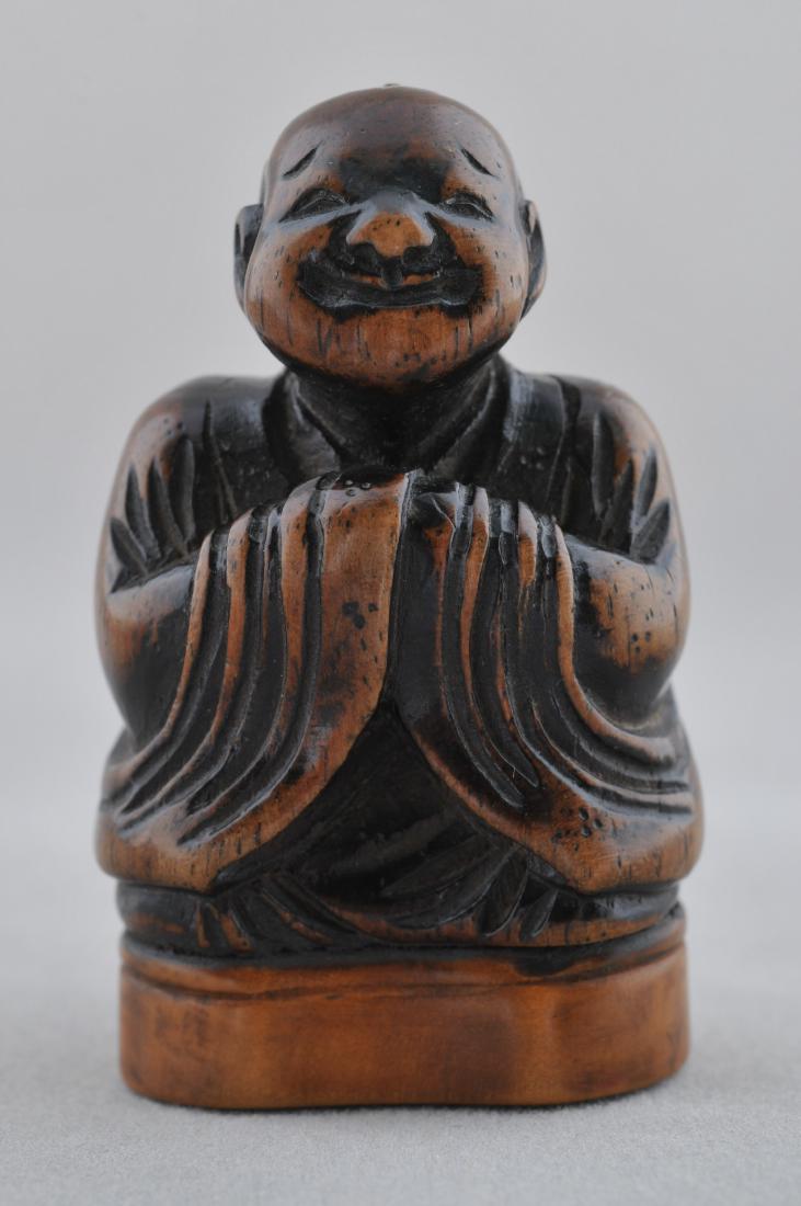 Seal Netsuke. Japan. 19th century. Carved wood. Seated: Seal Netsuke. Japan. 19th century. Carved wood. Seated figure of a smiling man. 2". All items in session one were collected by William H. Smith (1853-1923)