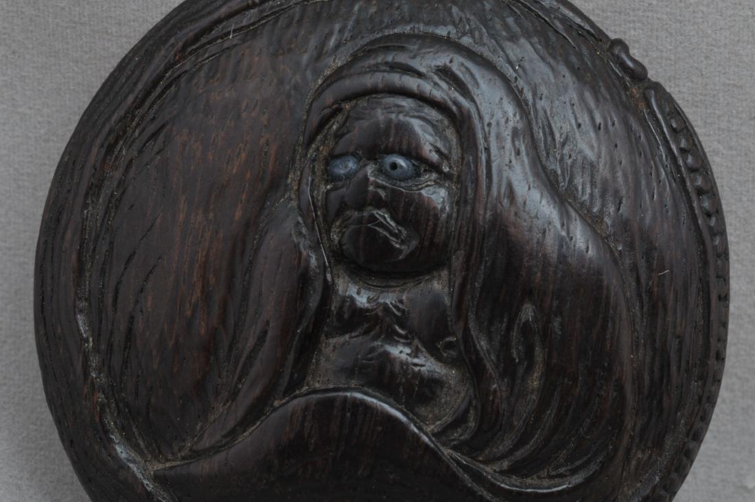 Carved wooden Manju Netsuke. 19th century. Daruma: Carved wooden Manju Netsuke. 19th century. Carved in relief with Daruma in the cave. 1-3/4" d. All items in session one were collected by William H. Smith (1853-1923)