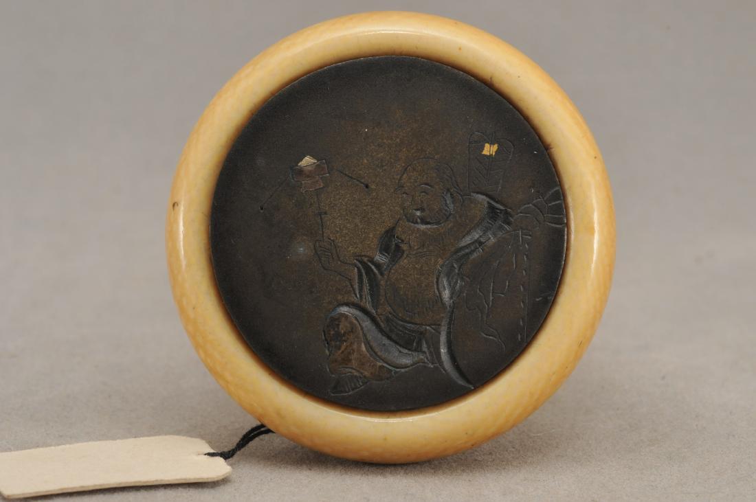 Kagamibuta Netsuke. Japan. ALERT!: Kagamibuta Netsuke. Japan. 19th century. Engraved Image of Hoitei playing with a toy. Gold and silver inlays. 1-3/4". All items in session one were collected by William H. Smith (1853-1923)) ALERT!!! 