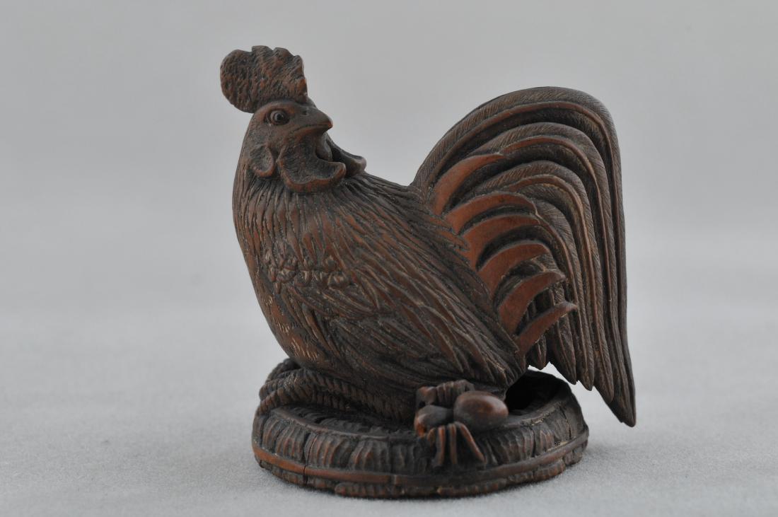Carved wooden Netsuke. Japan. 19th century. Study of a: Carved wooden Netsuke. Japan. 19th century. Study of a rooster, spider and a worn straw hat. 1-1/2". All items in session one were collected by William H. Smith (1853-1923)