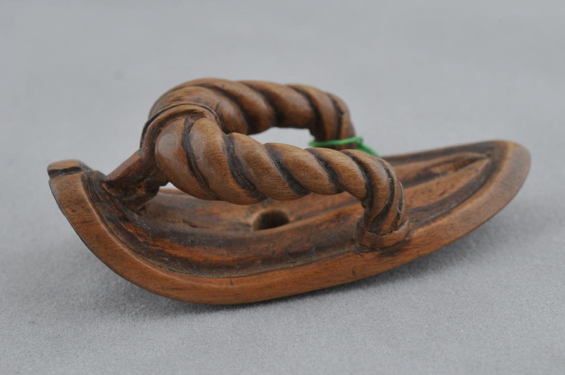 Carved wooden Netsuke. Japan. 19th century. Study of a: Carved wooden Netsuke. Japan. 19th century. Study of a sandal. 2-1/2". All items in session one were collected by William H. Smith (1853-1923)