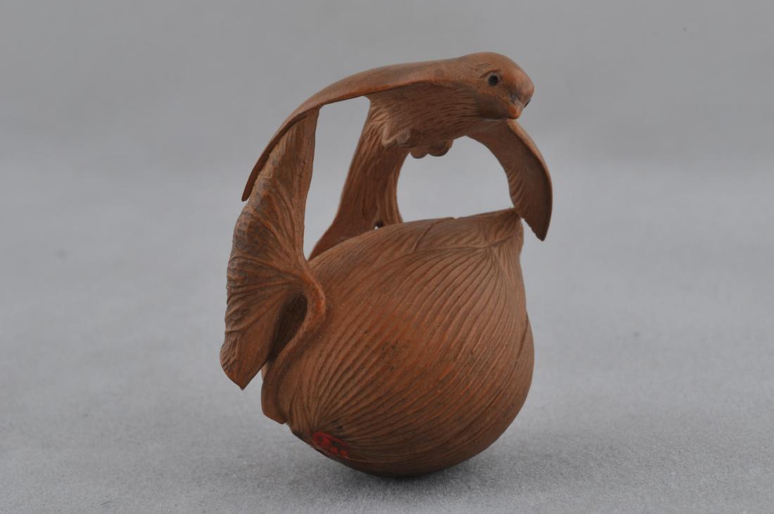 Carved wooden Netsuke. Japan. 19th century. Falcon and: Carved wooden Netsuke. Japan. 19th century. Falcon and lotus plant. Signed Masatsugu. 1-1/2" long. All items in session one were collected by William H. Smith (1853-1923)