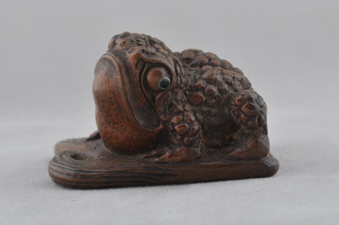 Carved wooden Netsuke. Japan. 18th/19th century. Frog: Carved wooden Netsuke. Japan. 18th/19th century. Frog on a lotus leaf. Inlaid eyes. 2". All items in session one were collected by William H. Smith (1853-1923)