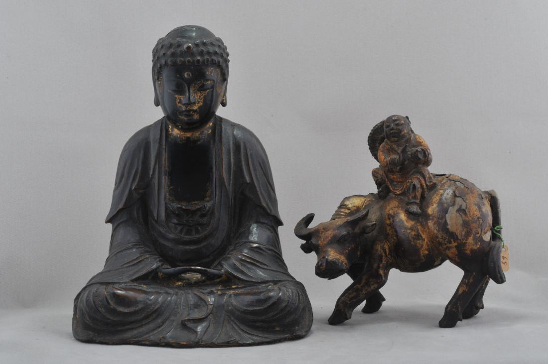 Lot of two carved wooden figures. To include: A seated (1 of 9)