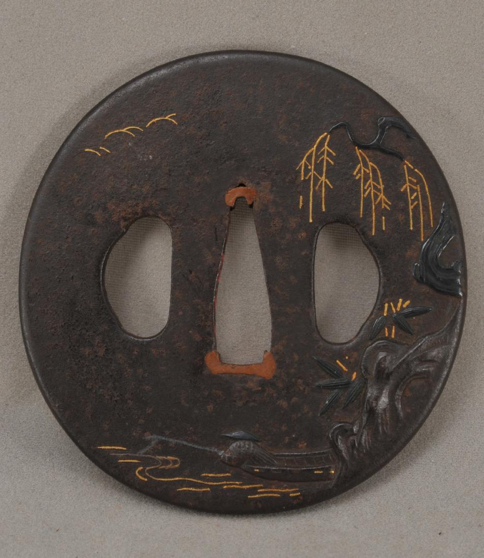 Handguard. Japan. 18th century. Steel carved with a: Handguard. Japan. 18th century. Steel carved with a fisherman inlaid with gold. 2-3/4". All items in session one were collected by William H. Smith (1853-1923)