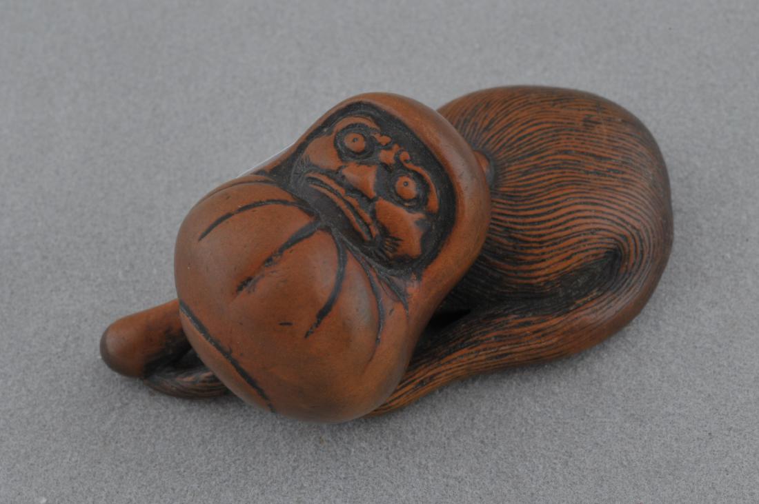 Carved wooden Netsuke. Japan. 19th C. Carving of Daruma: Carved wooden Netsuke. Japan. 19th century. Carving of a Daruma doll and a fly wisk (Hoso). 1-3/4". All items in session one were collected by William H. Smith (1853-1923)