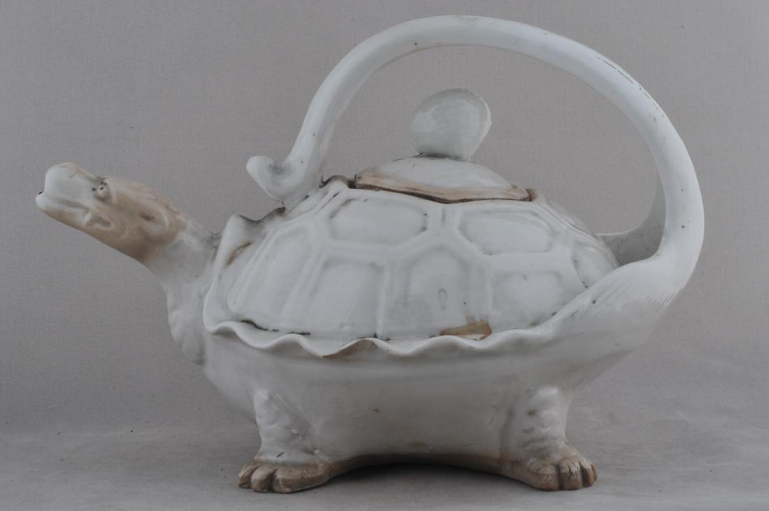Pottery wine ewer. Japan. 19th century. Tortoise shaped: Pottery wine ewer. Japan. 19th century. Tortoise shaped with a white glaze. 7-1/2" l. All items in session one were collected by William H. Smith (1853-1923)