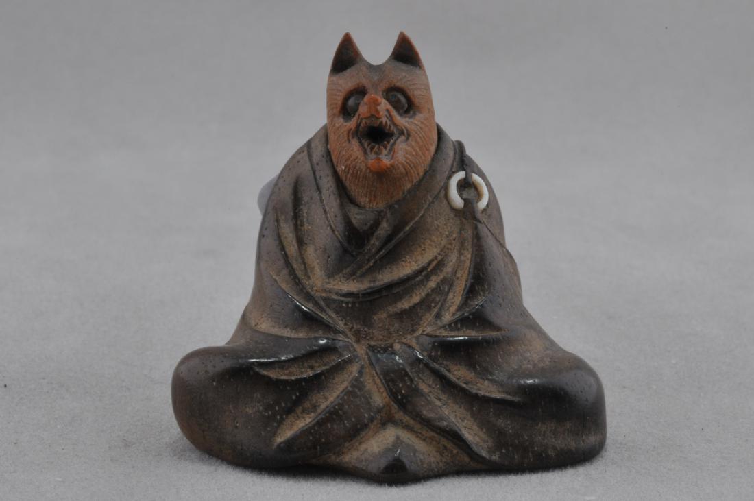 Wooden Netsuke. Japan. 19th century. Carving of a fox: Wooden Netsuke. Japan. 19th century. Carving of a fox priest with inlaid eyes. Signed on a vone cartouche (Anman?) 1-1/2". All items in session one were collected by William H. Smith (1853-1923)