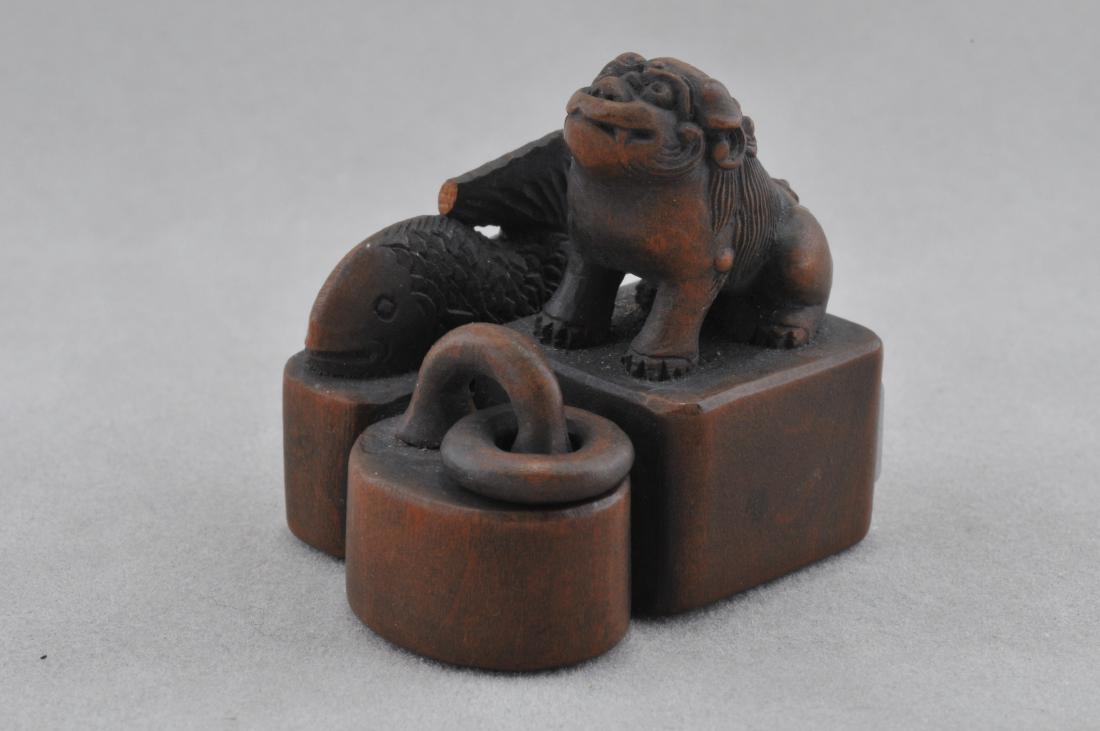 Carved wooden Netsuke. Japan. 19th C. Three Seals.: Carved wooden Netsuke. Japan. 19th century. Three seals. Finials of a Shishi, fish and jump ring. Seals intact. 1-1/2". All items in session one were collected by William H. Smith (1853-1923)