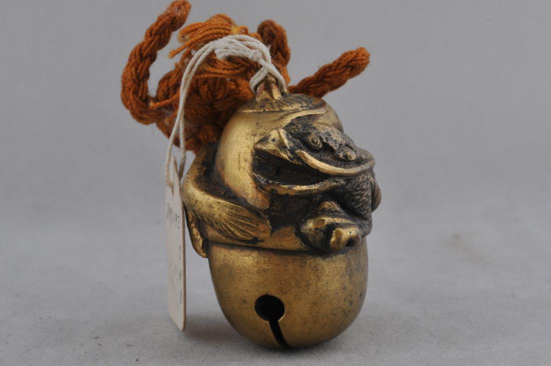 Gilt bronze netsuke. Japan. 19th century. Cast as a: Gilt bronze netsuke. Japan. 19th century. Cast as a bell with a swirling dragon. 1-1/2" l. All items in session one were collected by William H. Smith (1853-1923)