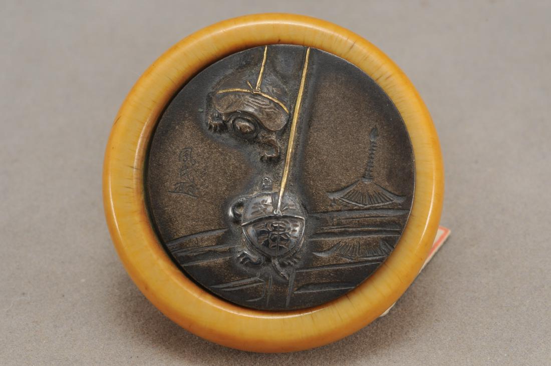 Kagamibuta Netsuke. Japan. 19th century. ALERT!: Kagamibuta Netsuke. Japan. 19th century. Mixed metal with a design of two tied tortoises and a pagoda. Signed Homin. All items in session one were collected by William H. Smith (1853-1923)) ALERT!!! O