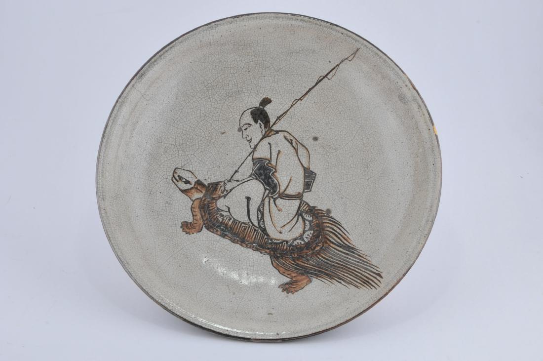 Stoneware bowl. Japan. 18th century. Setoware brown: Stoneware bowl. Japan. 18th century. Setoware brown decoration of a sennin on a tortoise scrolls and brown bands on the reverse, 15" d. All items in session one were collected by William H. Smith (185