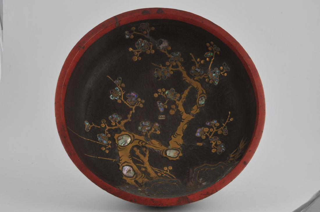 Carved wooden bowl. Japanese. 19th century. Interior: Carved wooden bowl. Japanese. 19th century. Interior decorated with a gold lacquered prunus tree with mother of pearl inlay. 16" d. All items in session one were collected by William H. Smith (1853-19