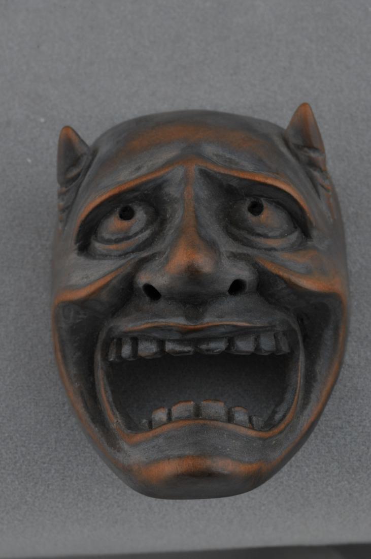 Carved wooden Netsuke. Japan. 19th century. Mask of an: Carved wooden Netsuke. Japan. 19th century. Mask of an Oni. 2". All items in session one were collected by William H. Smith (1853-1923)