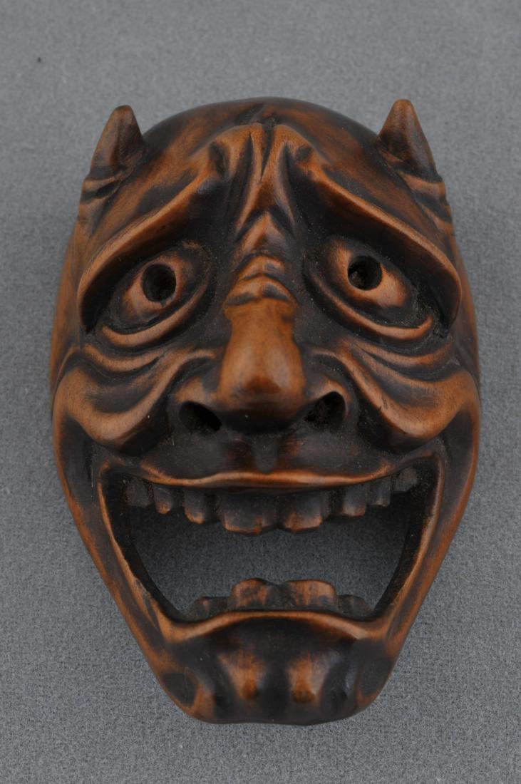 Wooden Netsuke. Japan. 19th century. Mask of an: Wooden Netsuke. Japan. 19th century. Mask of an oni-demon. 2-1/4". All items in session one were collected by William H. Smith (1853-1923)