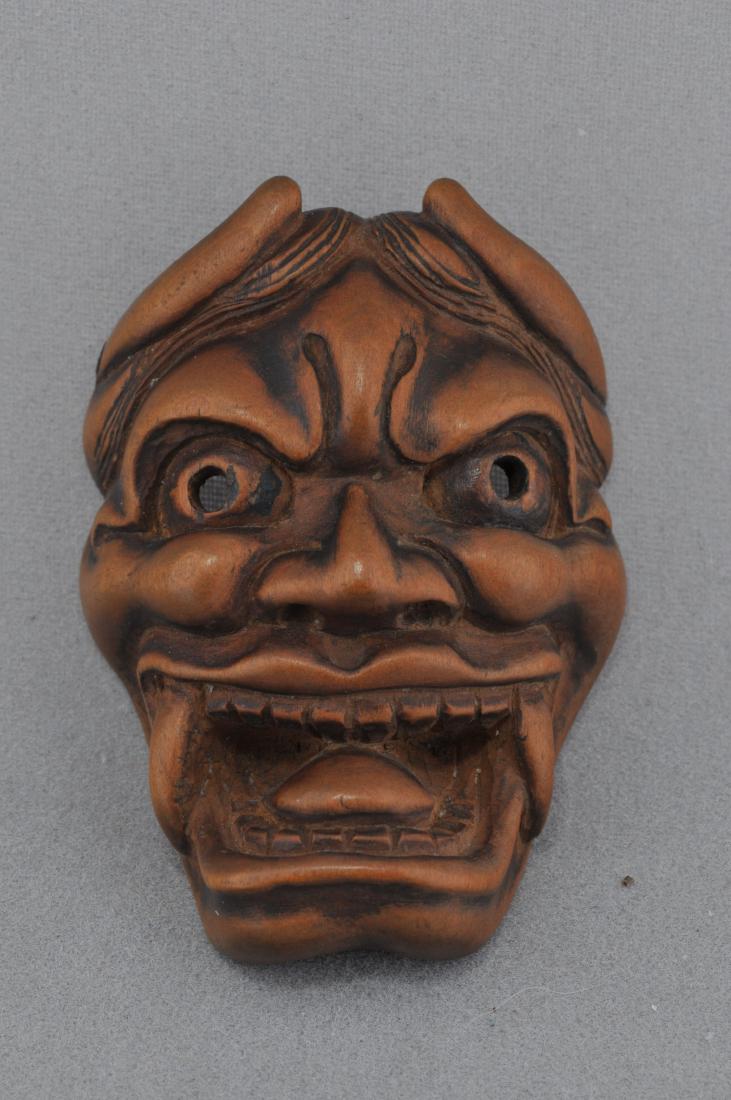Carved wooden Netsuke. Japan. 19th century. Oni mask.: Carved wooden Netsuke. Japan. 19th century. Oni mask. Signed. 1-3/4". All items in session one were collected by William H. Smith (1853-1923)