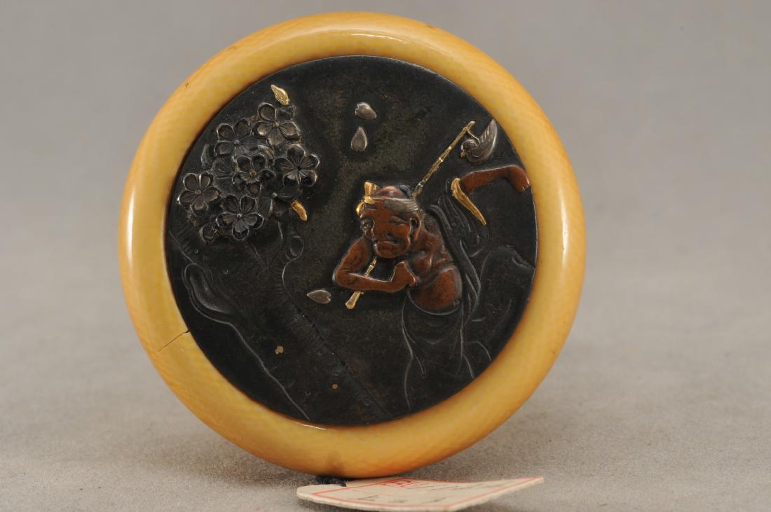 Kagamibuta Netsuke. Japan. 19th century. ALERT!: Kagamibuta Netsuke. Japan. 19th century. Mixed metal work. Decoration of a man beneath a flowering cherry tree. 1-3/4". All items in session one were collected by William H. Smith (1853-1923)) ALERT!!