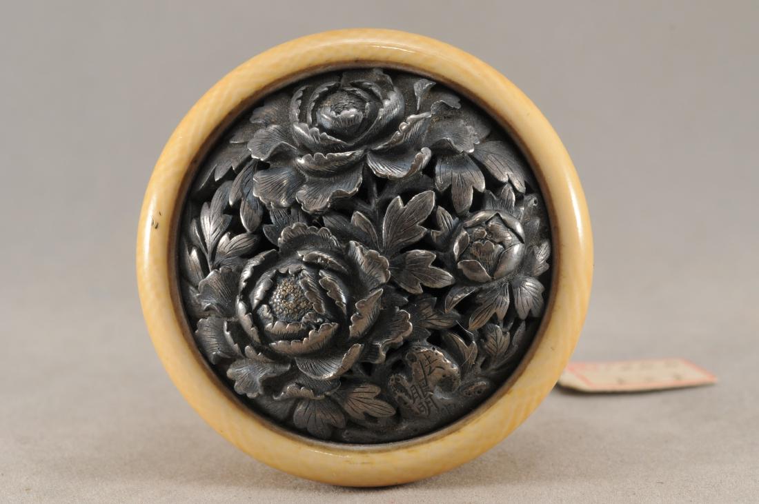 Kagamibuta Netsuke. Japan. 19th century. ALERT!: Kagamibuta Netsuke. Japan. 19th century. Repousse silver with a decoration of peony flowers. 2". All items in session one were collected by William H. Smith (1853-1923)) ALERT!!! ONLY THE CENTRAL INSE
