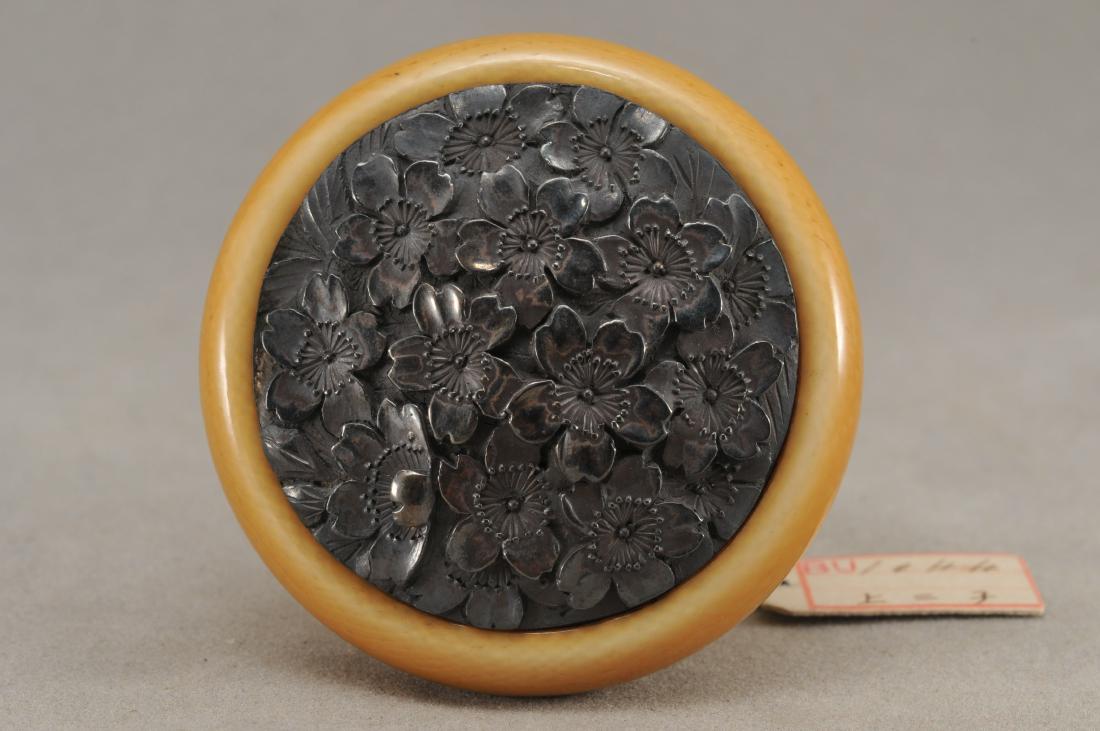 Kagamibuta Netsuke. Japan. 19th century. ALERT!: Kagamibuta Netsuke. Japan. 19th century. Repousse silver decoration of cherry blossoms. 1-3/4". All items in session one were collected by William H. Smith (1853-1923)) ALERT!!! ONLY THE CENTRAL INSER