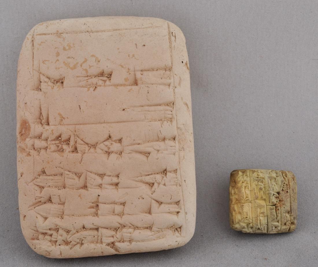 Two Cuniform Clay tablets. One reading "Sin gashid the (1 of 5)