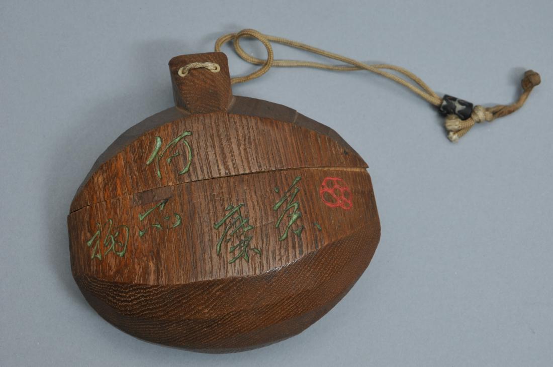 Inro. Japan. 19th century. Carved wood with: Inro. Japan. 19th century. Carved wood with inscriptions. Rounded shape. 5" w. 4-3/4" h. All items in session one were collected by William H. Smith (1853-1923)