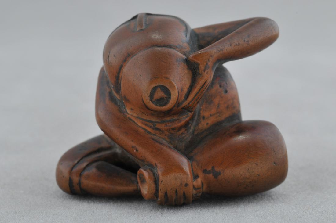 Carved wooden Netsuke. Japan. 19th century. Study of a: Carved wooden Netsuke. Japan. 19th century. Study of a man drinking sake. 1". All items in session one were collected by William H. Smith (1853-1923)