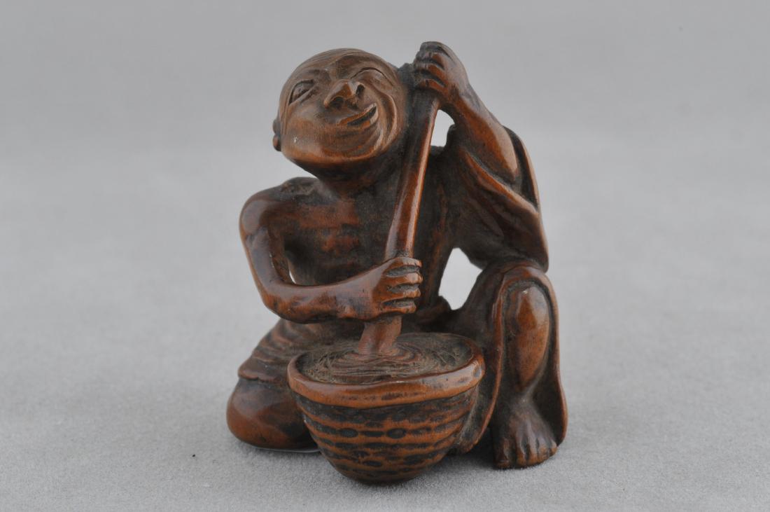Carved wooden Netsuke. Japan. 18th/19th century. Figure: Carved wooden Netsuke. Japan. 18th/19th century. Figure of a man stirring a pot. 1-1/2". All items in session one were collected by William H. Smith (1853-1923)