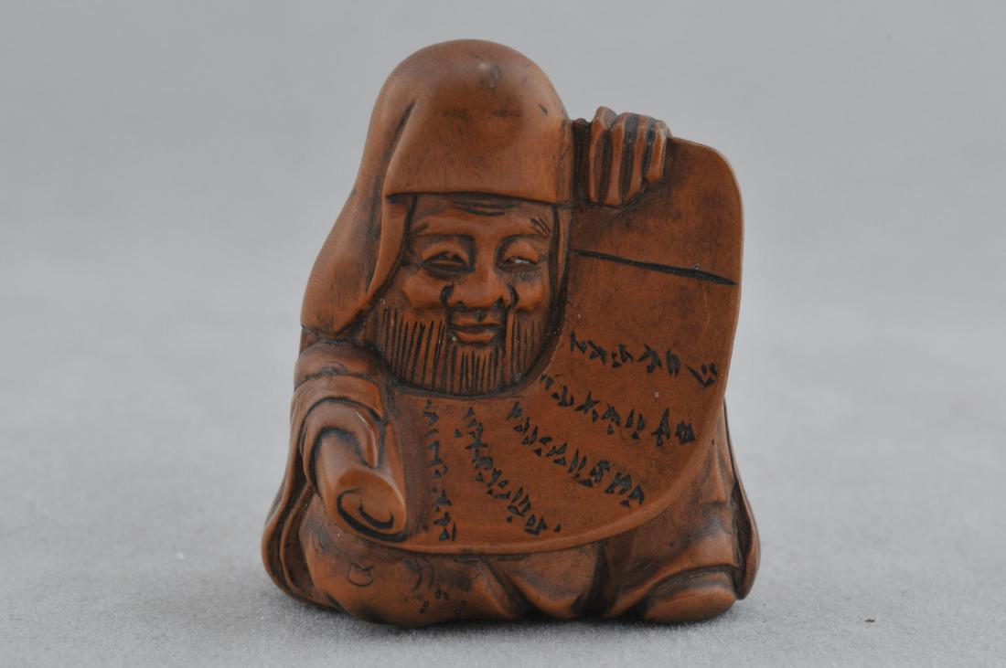 Carved wooden Netsuke. Japan. 19th century. Figure of: Carved wooden Netsuke. Japan. 19th century. Figure of Jurojin with a scroll. 1-1/4". All items in session one were collected by William H. Smith (1853-1923)