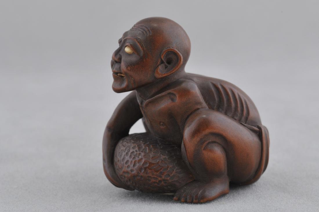 Wooden Netsuke. Japan. 19th century. Carved figure of a: Wooden Netsuke. Japan. 19th century. Carved figure of a weight lifter. Cartouche and inlays missing. 1-1/4". All items in session one were collected by William H. Smith (1853-1923)