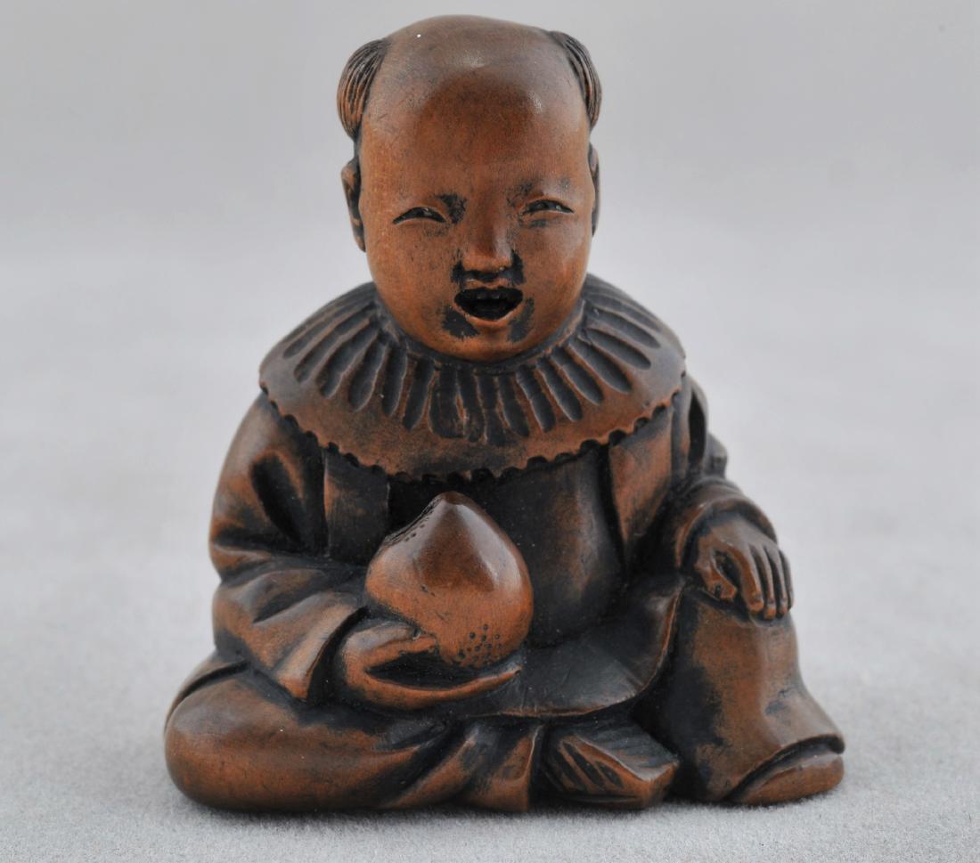 Carved wooden Netsuke. Japan. 19th century. Small boy: Carved wooden Netsuke. Japan. 19th century. Small boy (karako) with a peach. Signed Hoichi. 1-1/2". All items in session one were collected by William H. Smith (1853-1923)