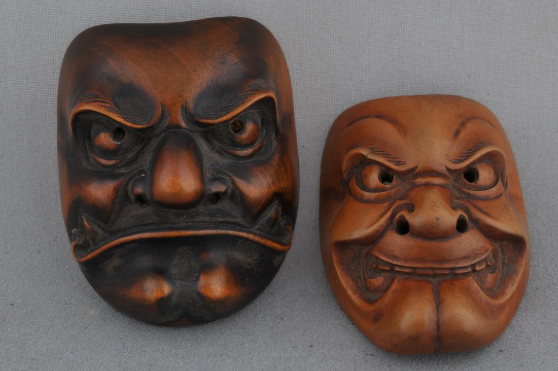 Lot of two wooden Netsuke. Japan. 19th century. Masks: Lot of two wooden Netsuke. Japan. 19th century. Masks carved in the form of demons. 1-3/4" and 2". All items in session one were collected by William H. Smith (1853-1923)