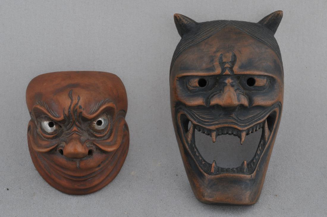 Lot of two wooden Netsuke. Japan. 19th century. Masks.: Lot of two wooden Netsuke. Japan. 19th century. Masks. A demon and a comic figure with inlaid silver eyes. 3" and 1-3/4". All items in session one were collected by William H. Smith (1853-1923)
