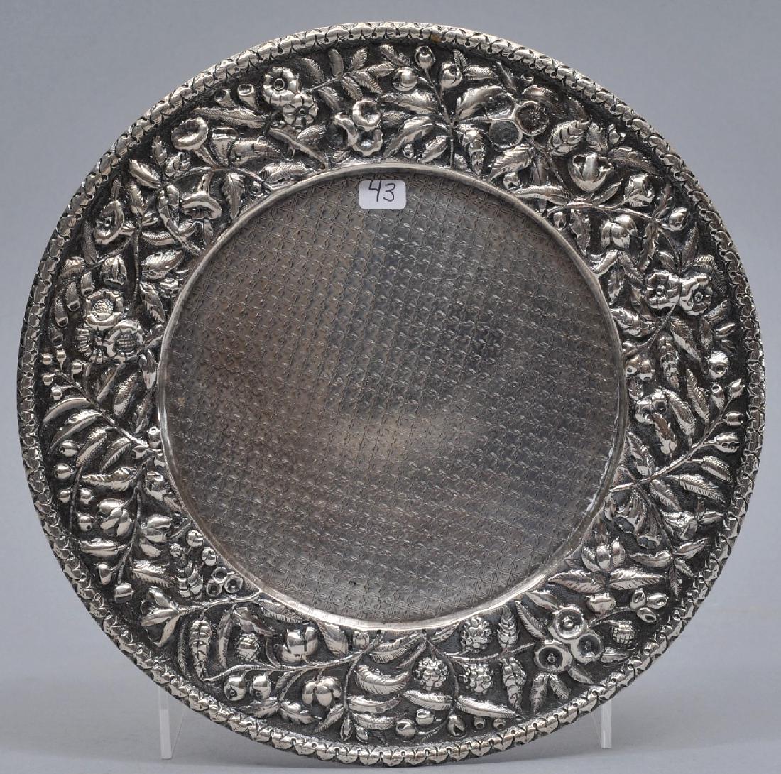 S. Kirk & Son. Early footed wine coaster. Floral: S. Kirk & Son. Early footed wine coaster. Floral repousse border and X pattern center decoration. 11 oz. mark. 8" diameter. 9.5 ozt.
