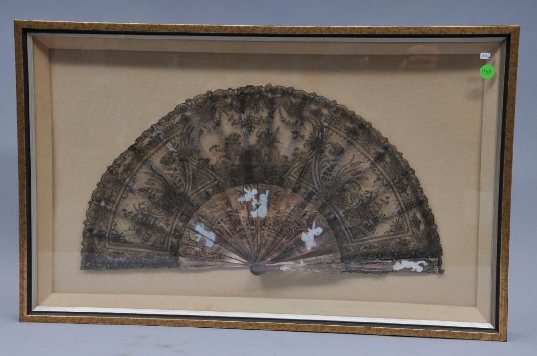 19th century French Black Chantilly Lace fan with putti: 19th century French Black Chantilly Lace fan with putti design. Intricately carved M.O.P. handle with white M.O.P. inlay. Missing case that was stamped "Paris Duvelleroy Paris London". Framed in a sha