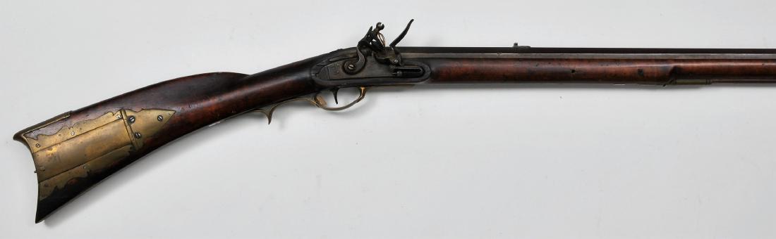Signed "B*T" rifle 51-1/2" overall .45 Cal. 36-1/8": Signed "B*T" rifle 51-1/2" overall .45 Cal. 36-1/8" seven groove octagon BBL engraved "B*T" at breech flat with a tombstone tang. 4-3/8"x3/4" unsigned lock with a roller Frizzen and engraving at pan a