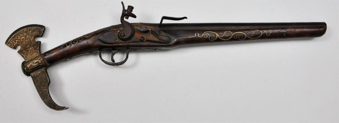 Middle Eastern style Flintlock pistol. 12-1/4" overall: Middle Eastern style Flintlock pistol. 12-1/4" overall .63 Cal. 12-1/4" BBL. 4-3/8"x7-8" unmarked lock plate. Wire inlay on stock and a 6-1/2" ax head butt plate. Condition: Light rust on lock plate a