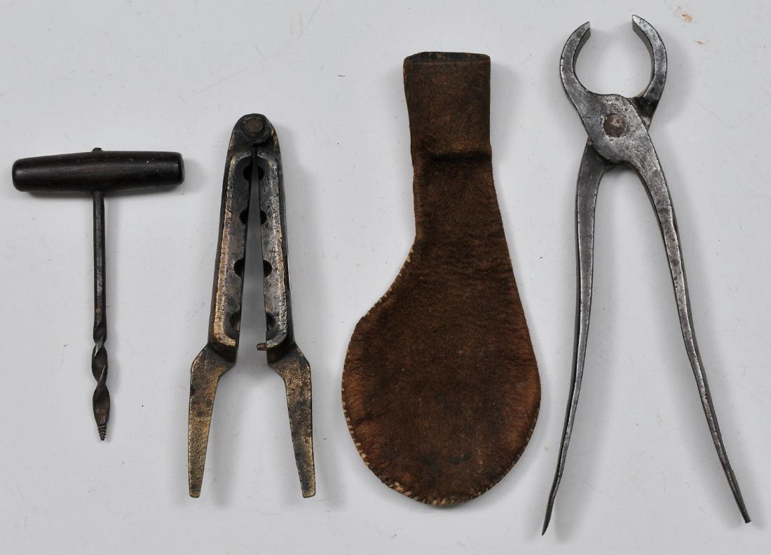 Lot of four items. 18th century brass gang mold from: Lot of four items. 18th century brass gang mold from .67 to .55 Cal. 5-1/2" overall. A Gimlet, shot pouch, and hand wrought nips.