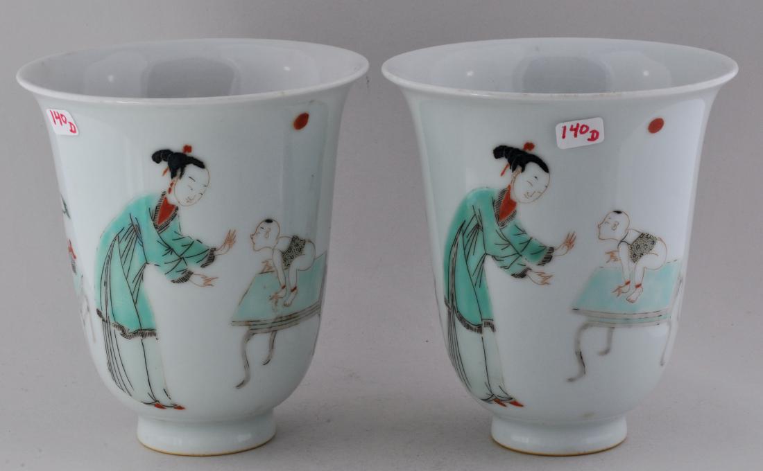 Pair of porcelain beakers. China. 19th century. K'ang: Pair of porcelain beakers. China. 19th century. K'ang His style decoration of women and children in Famille Verte palette. 4" diameter. 4-1/2" high.